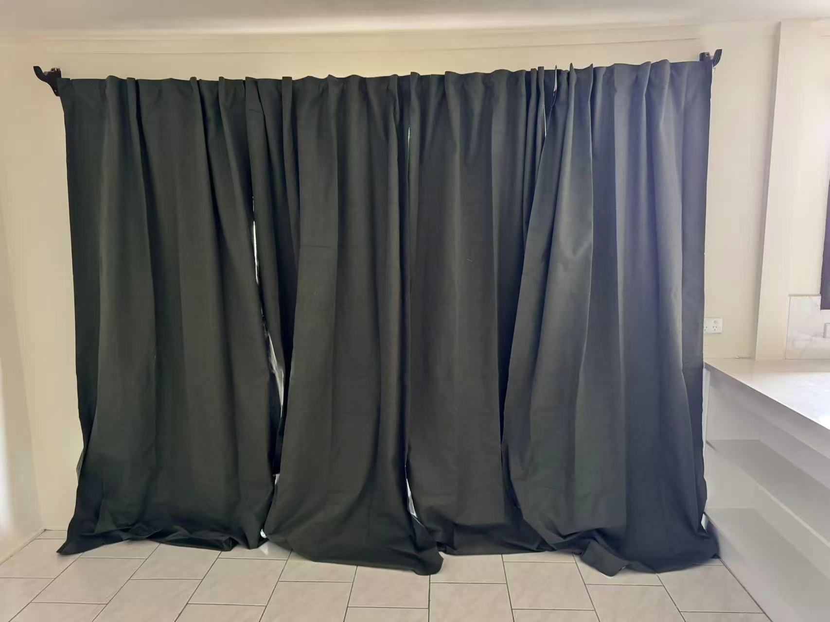 Ellis Services full-width dark curtain installation in a living room